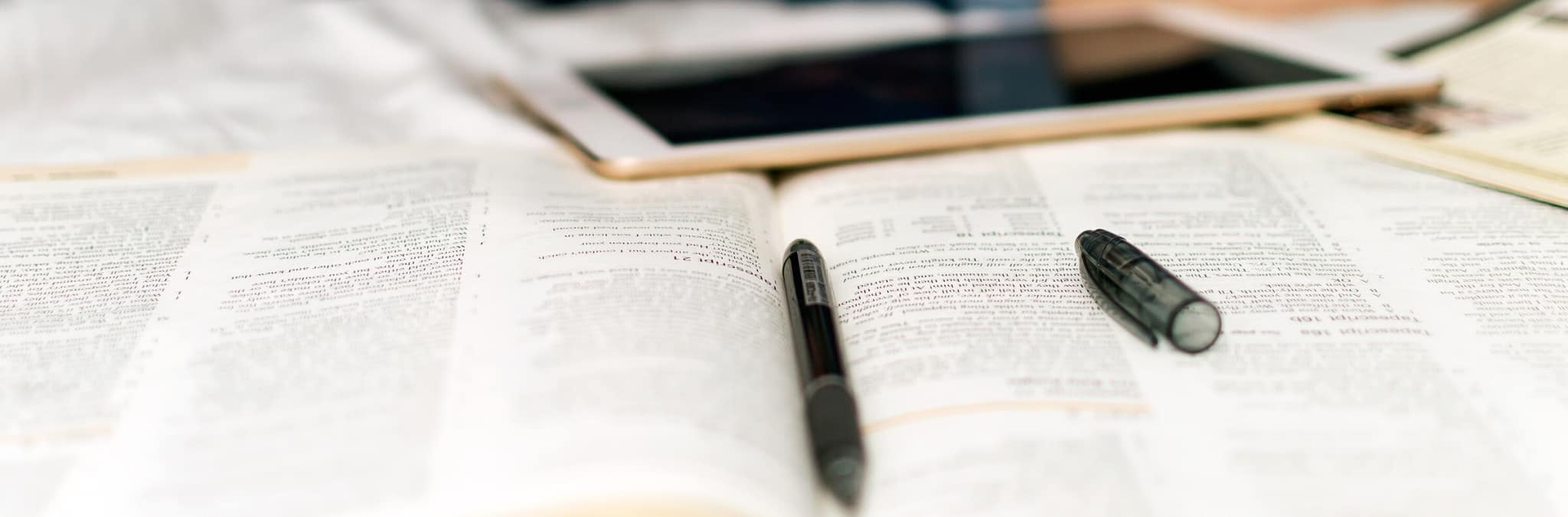 canetas livro e tablet