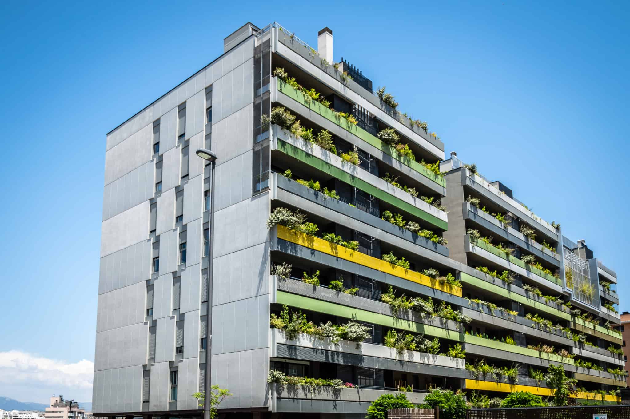 prédio moderno com varandas com plantas e 8 andares