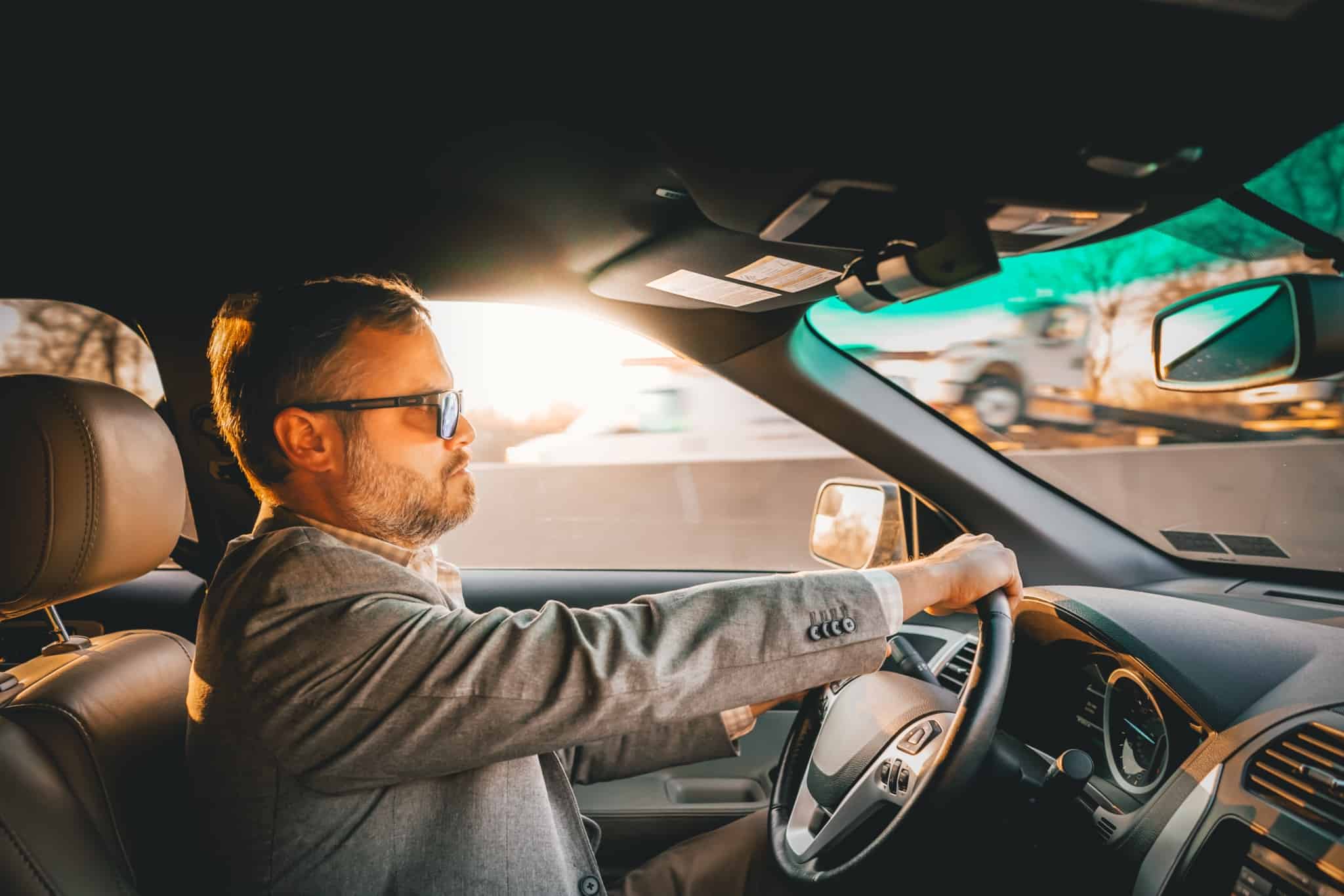 homem de quarenta anos a guiar o seu automovel