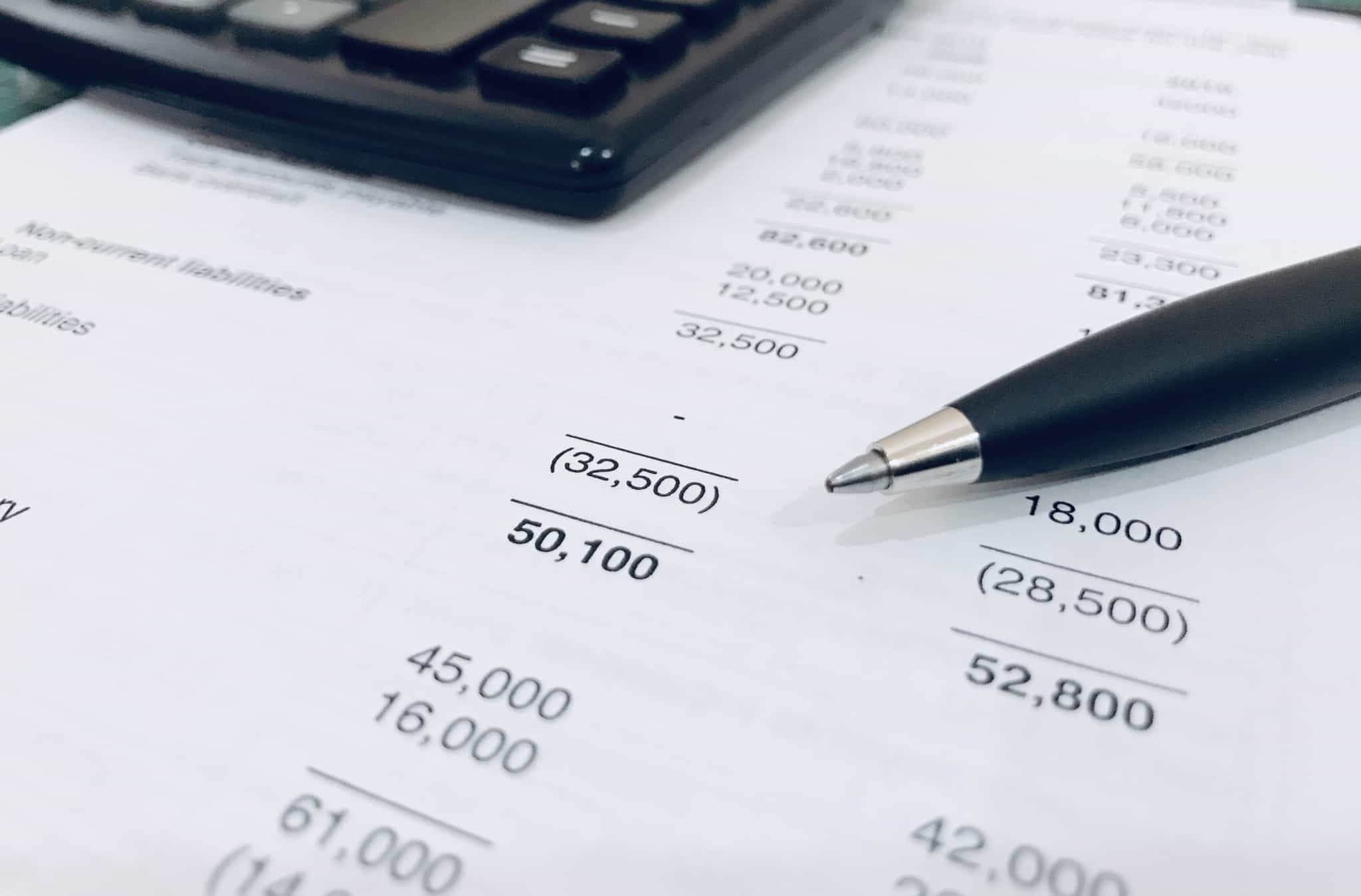 papel e caneta com uma calculadora ao lado