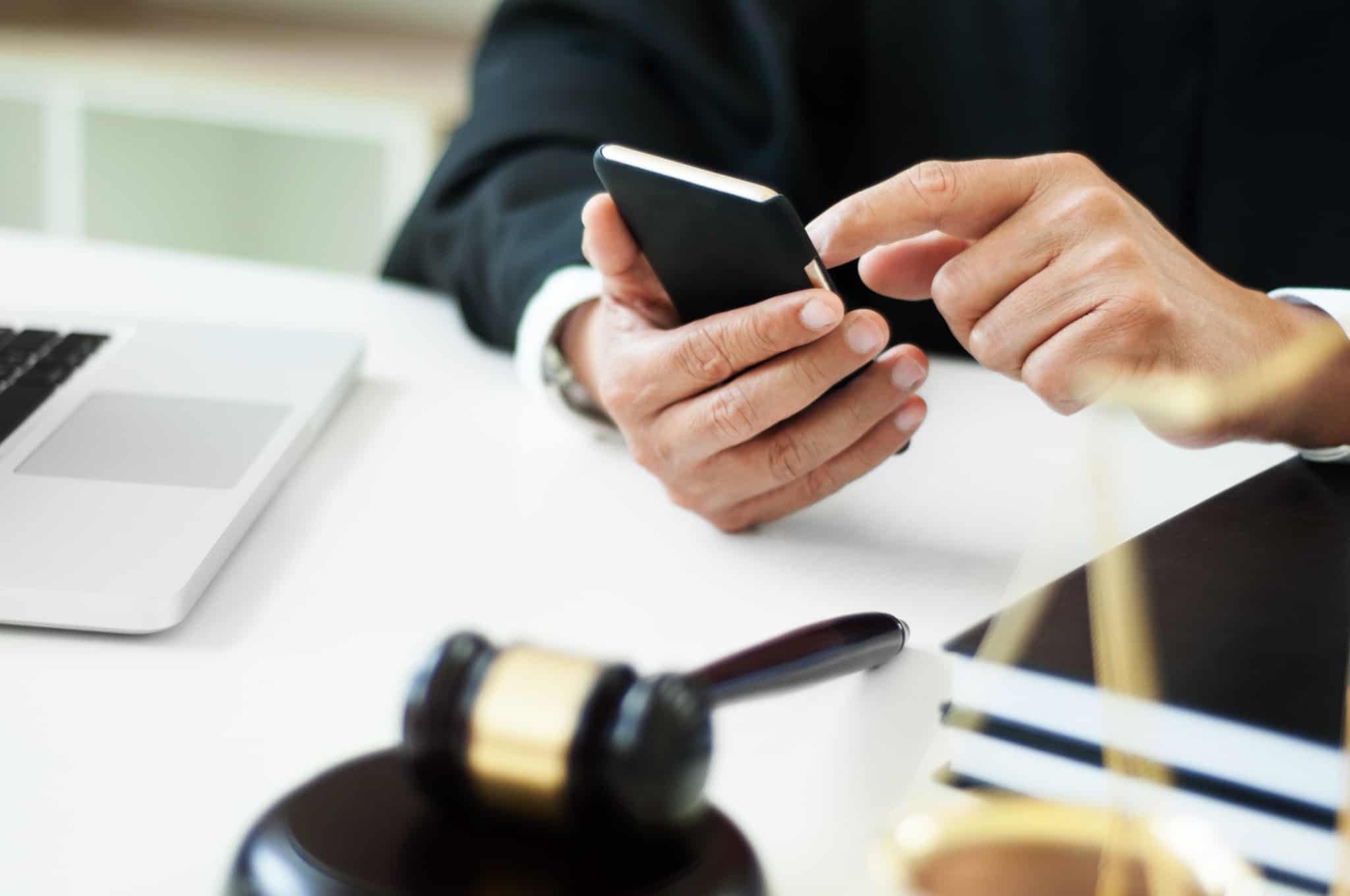 leilao bens finanças pessoa a mexer no telemóvel
