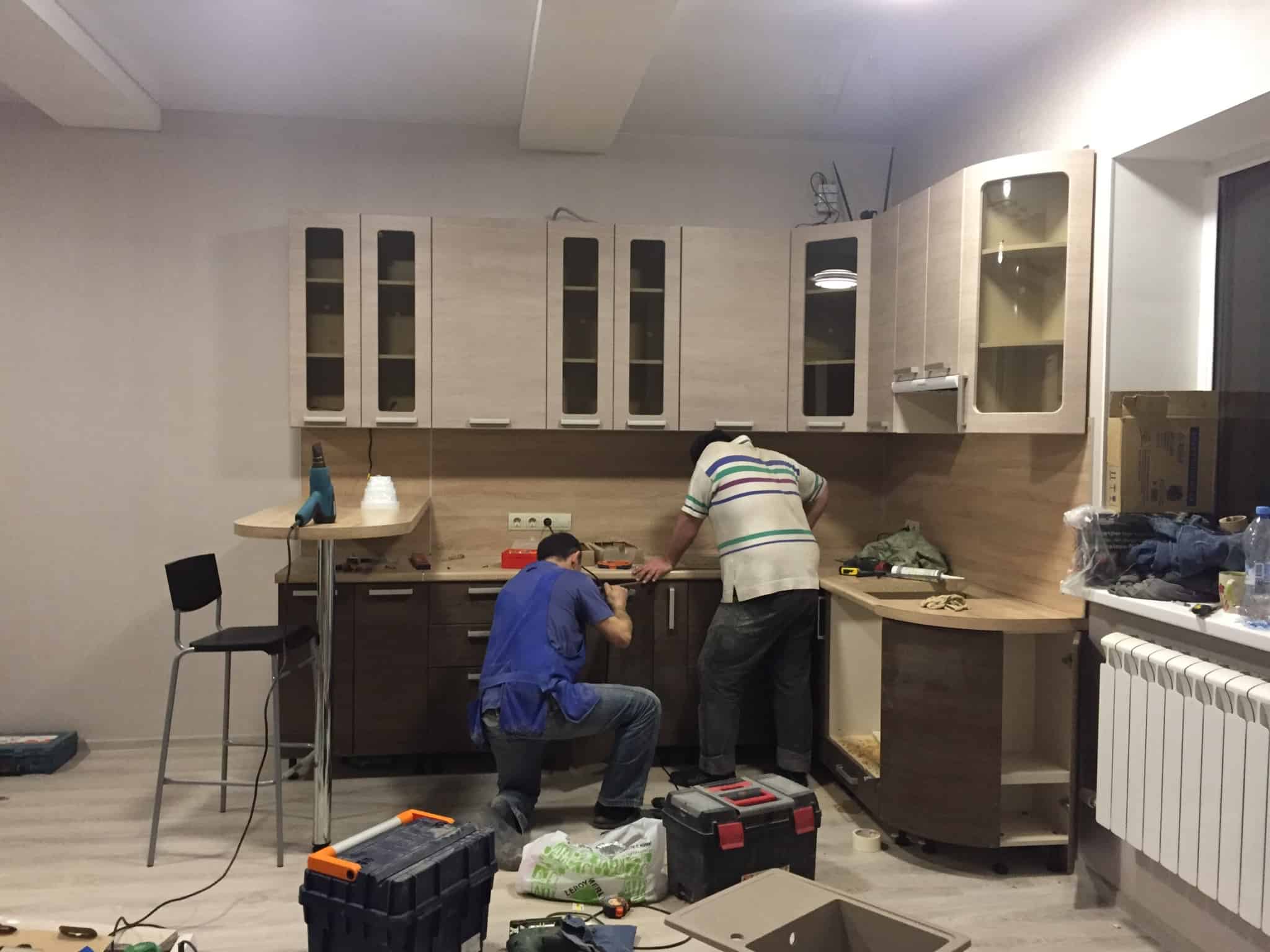 Duas pessoas a montarem um cozinha