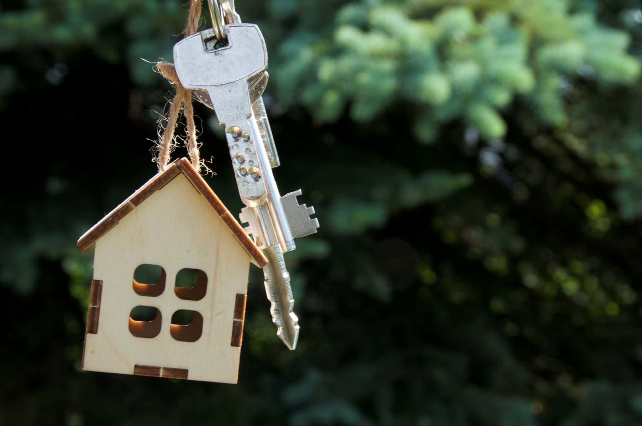Chaveiro com chave de casa e uma casinha em madeira, a evocar fim da moratória