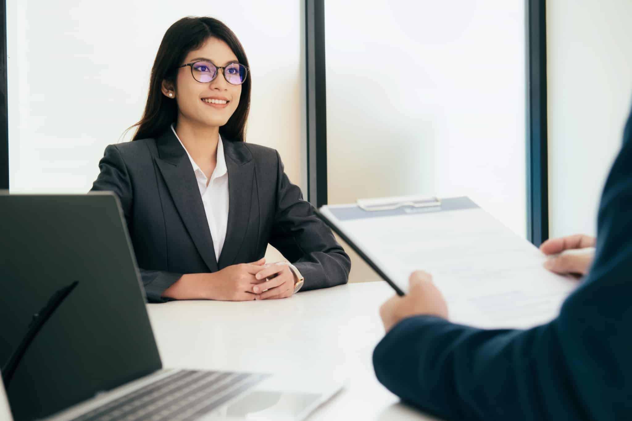 jovem mulher, recem licenciada, sorridente, confiante e com apresentação cuidada, na sua primeira entrevista de emprego