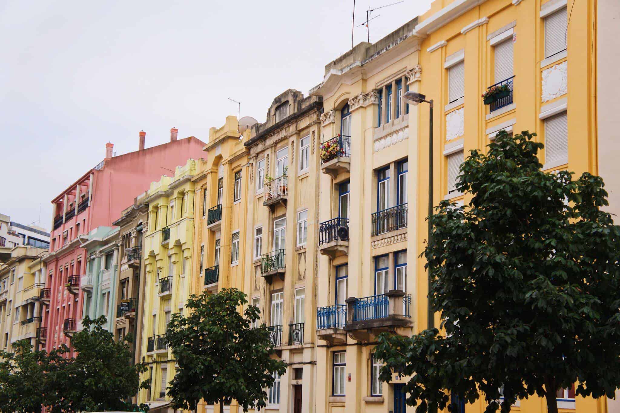 prédios de várias cores e árvores â frente
