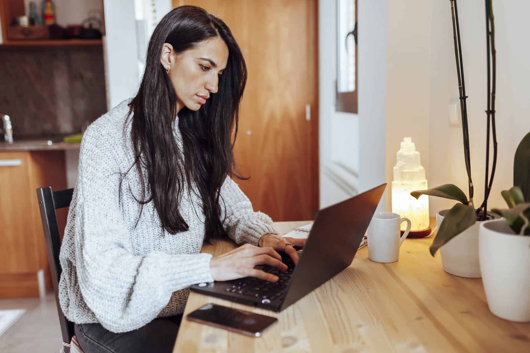 jovem trabalhadora a consultar no computador todas as obrigações e benefícios dos trabalhadores independes
