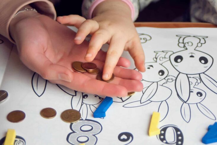 mãe a ensinar criança a contar moedas